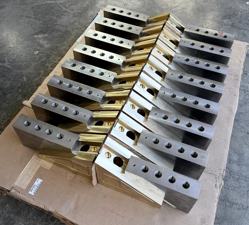 Finished machined parts arranged in two rows